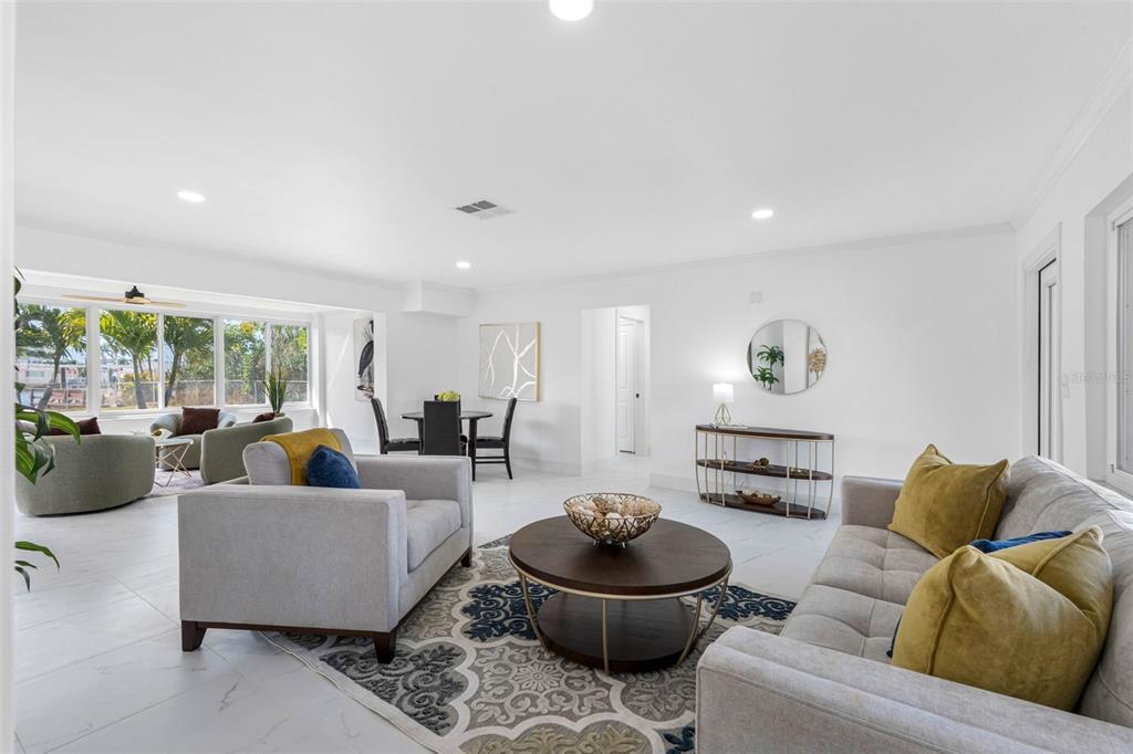 785 115th Avenue Treasure Island, FL 33706 - Photo 9 of 46 a living room with furniture and a wooden floor