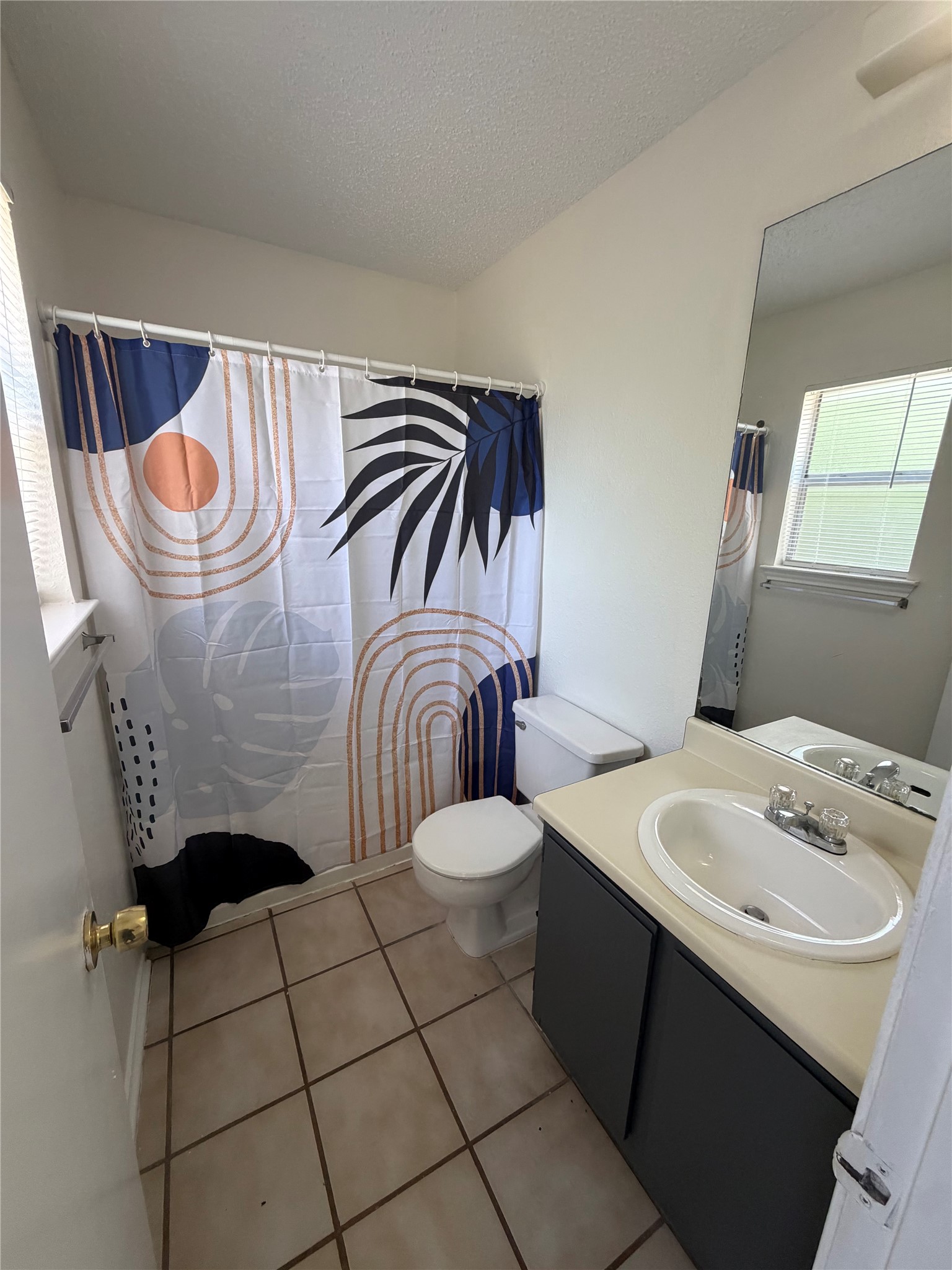 2016 Redwing Way Round Rock, TX 78664 - Photo 9 of 19 Primary Bathroom:
A well-lit bathroom features tiled flooring and a convenient vanity.