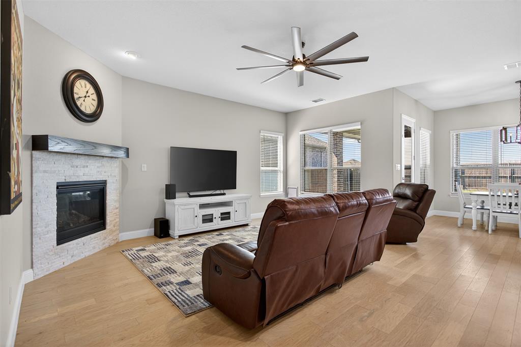 6829 Danridge Road Rowlett, TX 75089 - Photo 8 of 28 a living room with furniture a clock and a flat screen tv