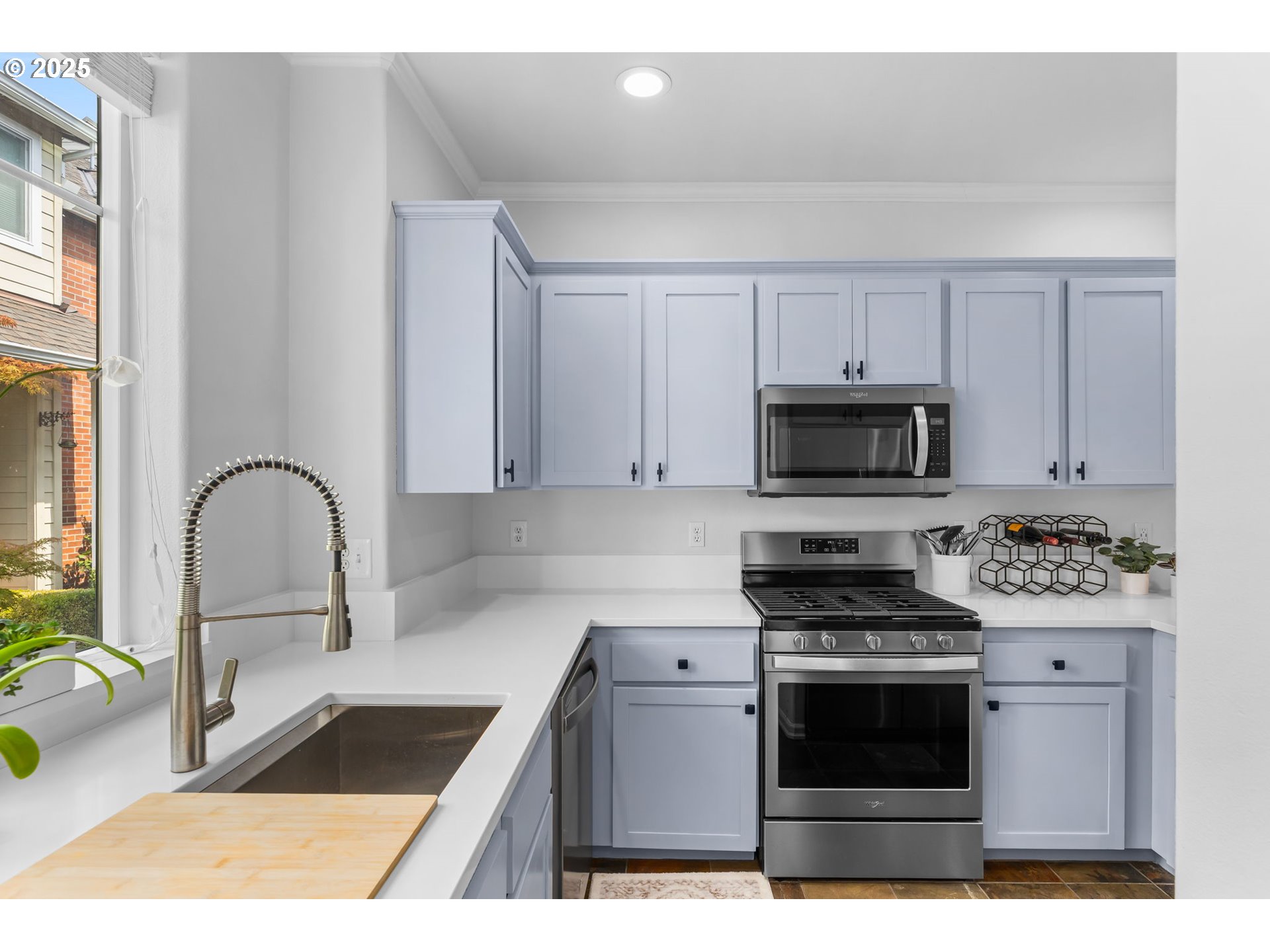 436 5th Street Lake Oswego, OR 97034 - Photo 10 of 35 a kitchen with stainless steel appliances kitchen island granite countertop a stove a sink and a microwave
