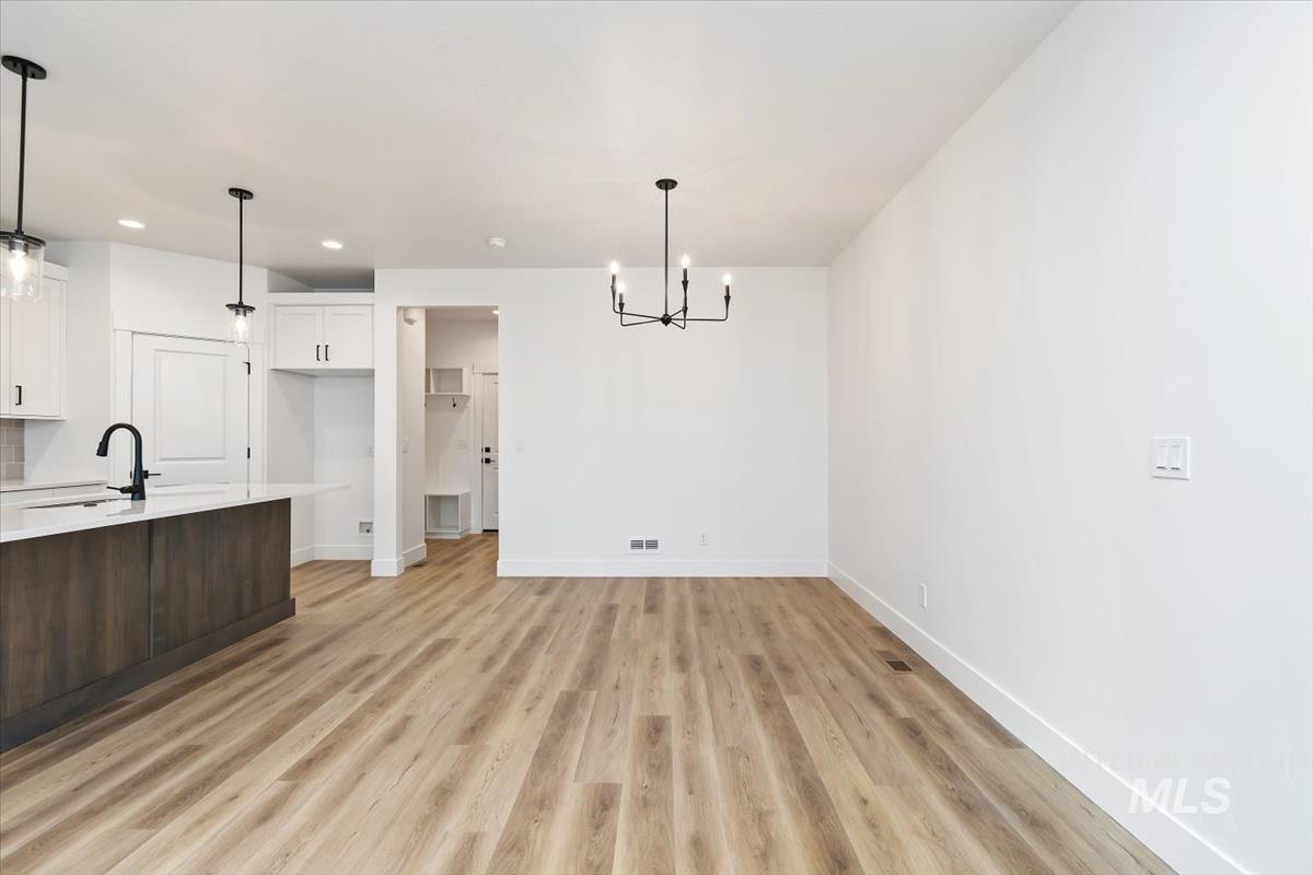 736 South Calhoun Lane Star, ID 83669 - Photo 11 of 42 Unfurnished dining area with hanging lights and light wood-type flooring