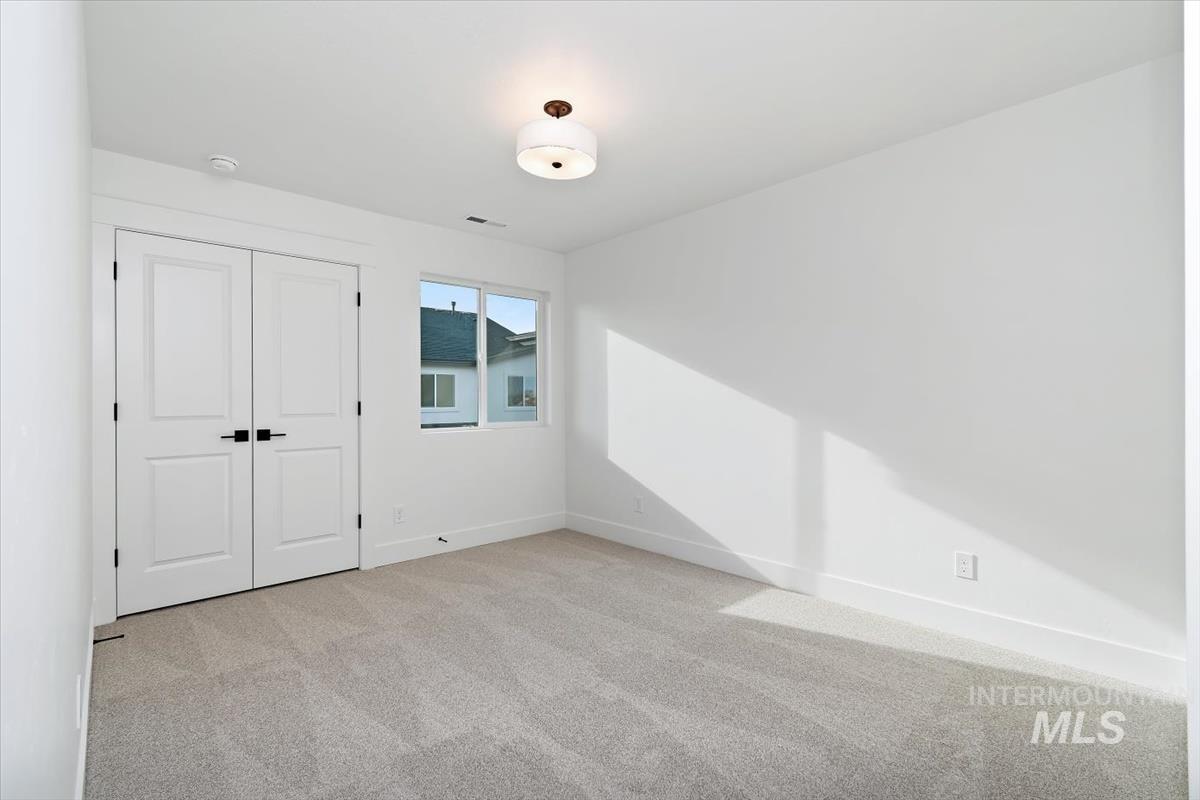 736 South Calhoun Lane Star, ID 83669 - Photo 14 of 42 Unfurnished bedroom with light colored carpet and a closet