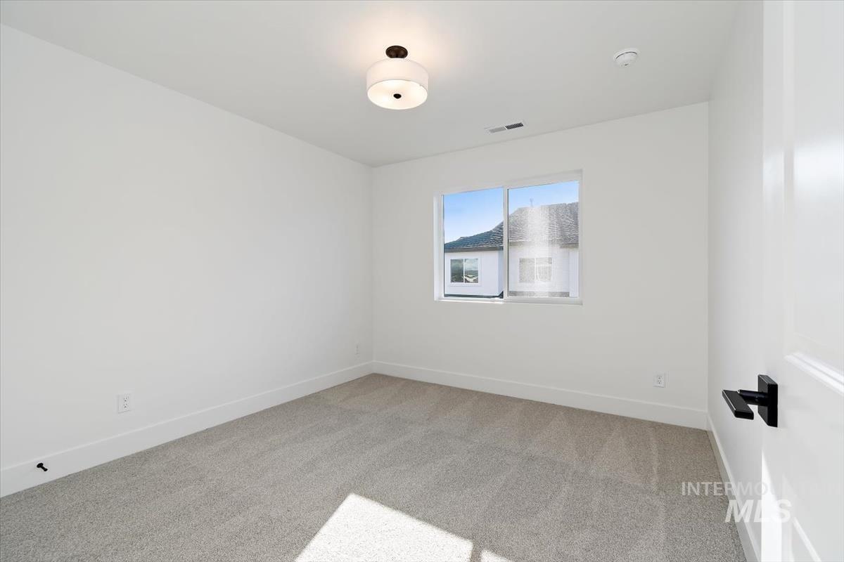 736 South Calhoun Lane Star, ID 83669 - Photo 16 of 42 Empty room with light colored carpet and baseboards