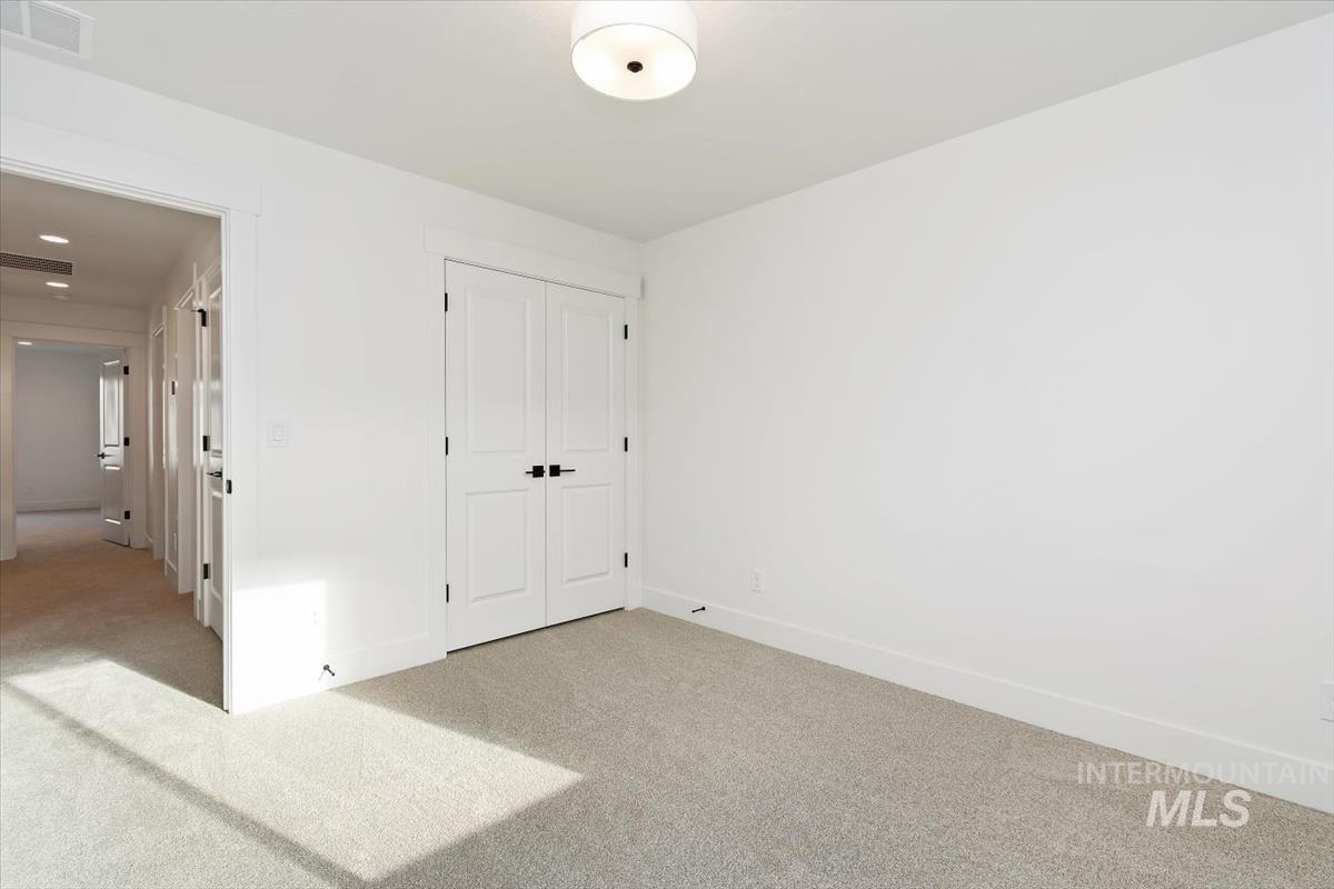 736 South Calhoun Lane Star, ID 83669 - Photo 17 of 42 Unfurnished bedroom with carpet floors and a closet
