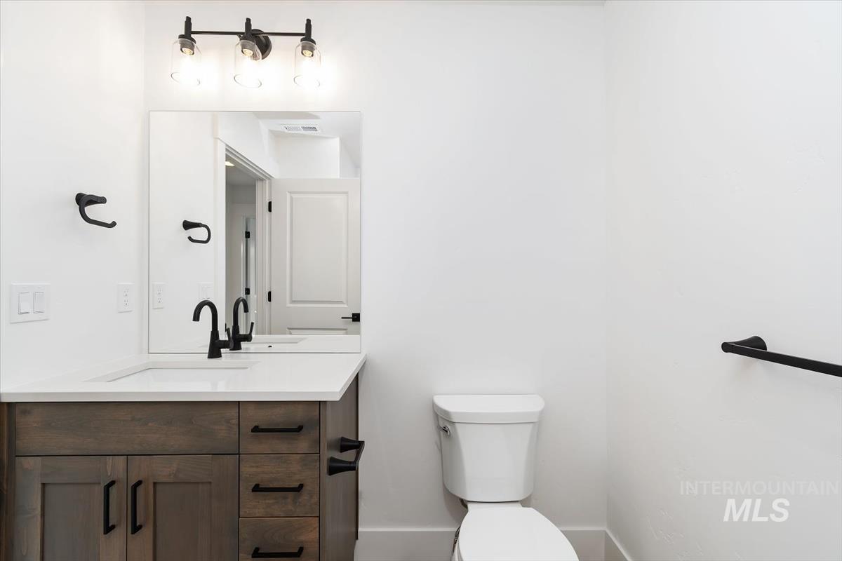 736 South Calhoun Lane Star, ID 83669 - Photo 19 of 42 Half bathroom featuring toilet and vanity