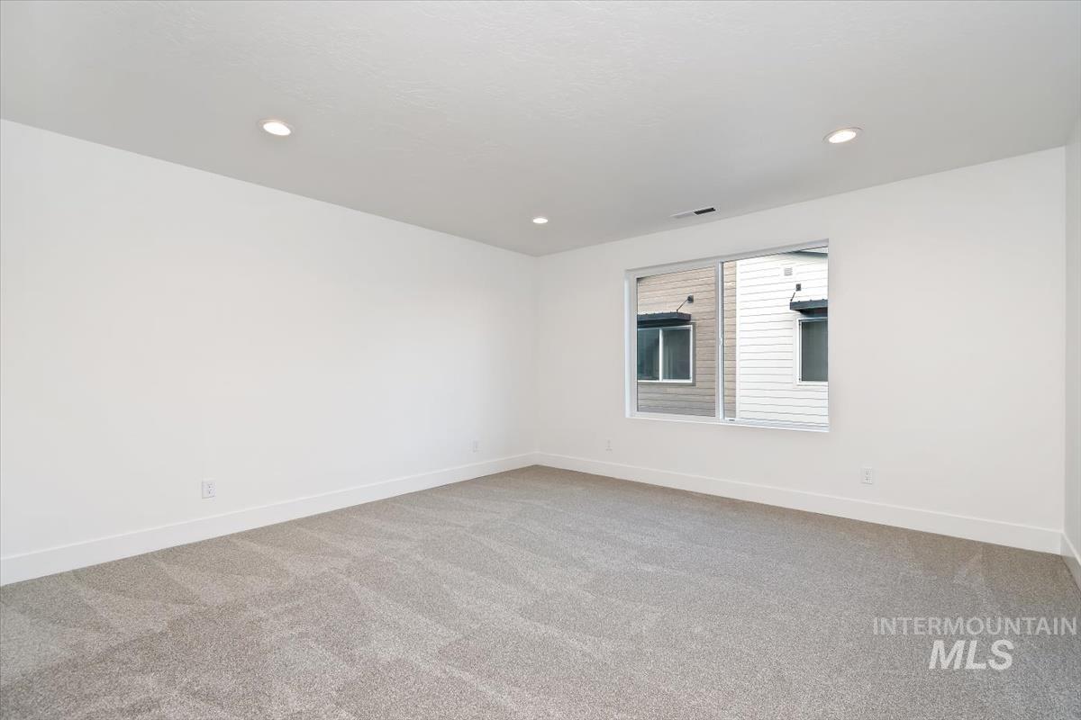 736 South Calhoun Lane Star, ID 83669 - Photo 21 of 42 Empty room featuring light colored carpet and recessed lighting