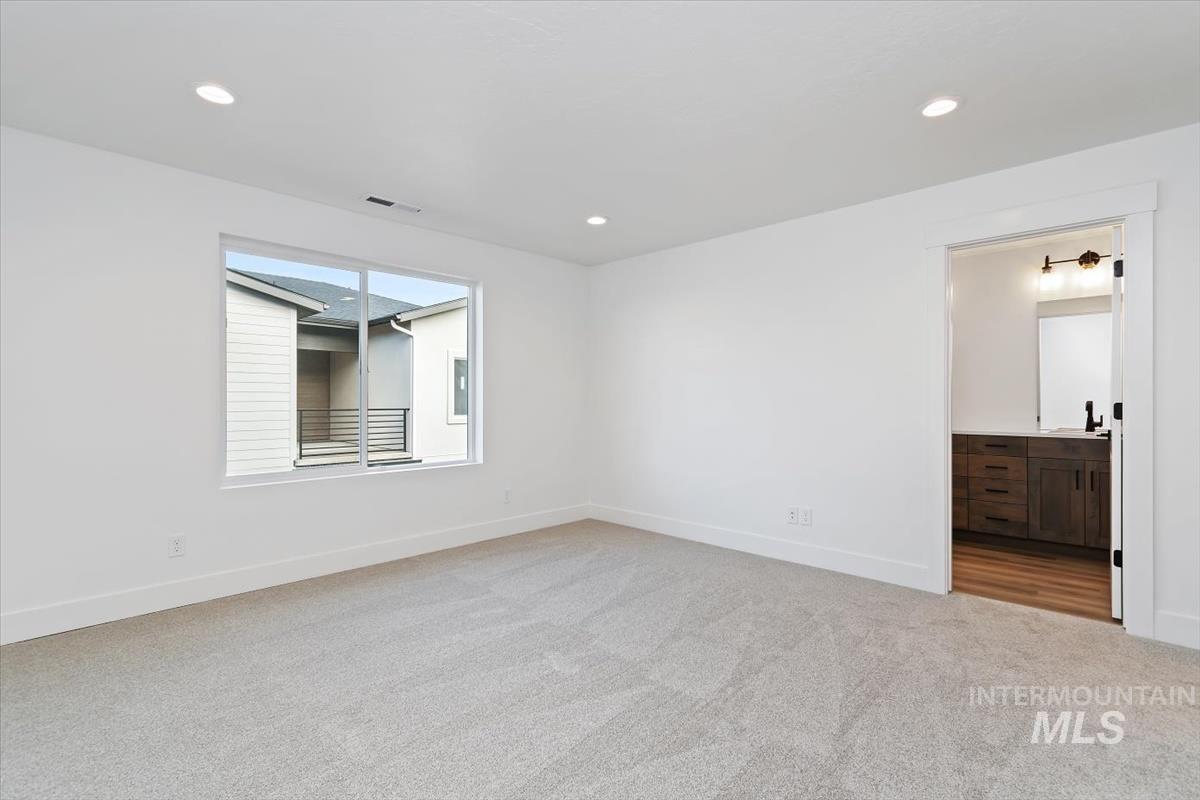 736 South Calhoun Lane Star, ID 83669 - Photo 23 of 42 Spare room with light colored carpet and recessed lighting