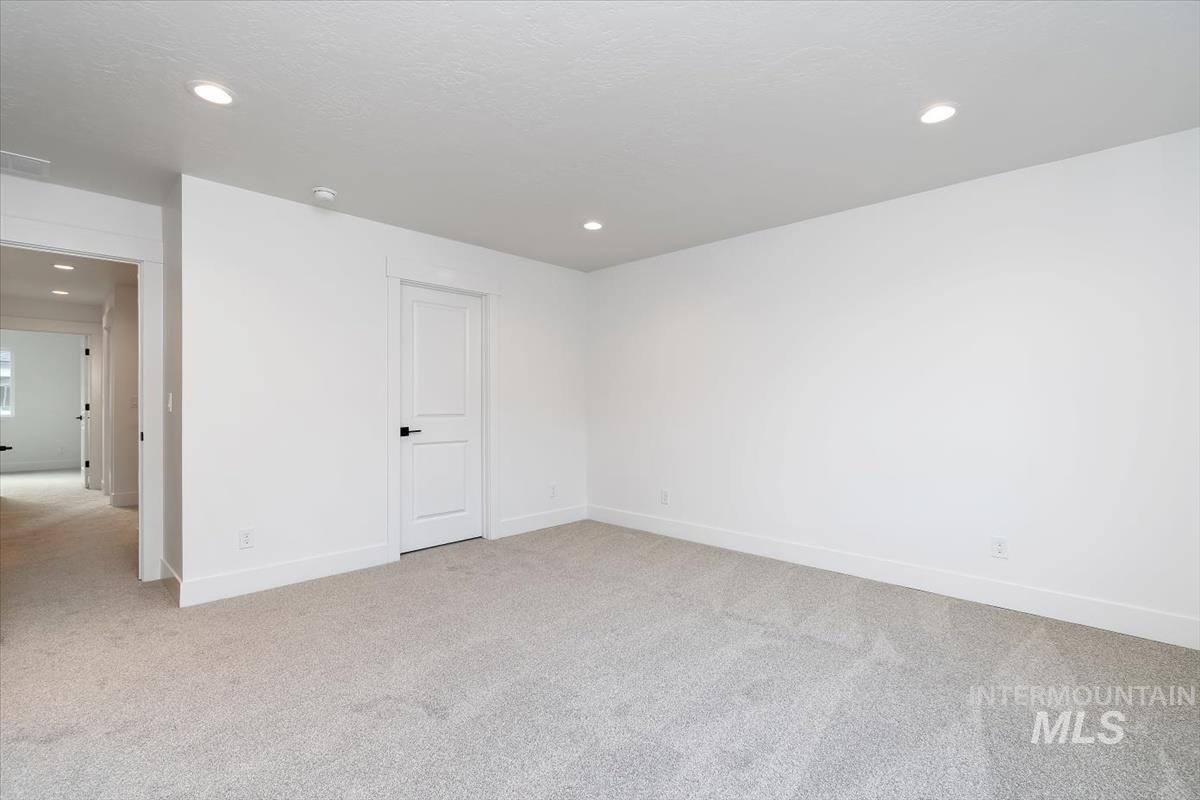736 South Calhoun Lane Star, ID 83669 - Photo 24 of 42 Empty room with light carpet and recessed lighting