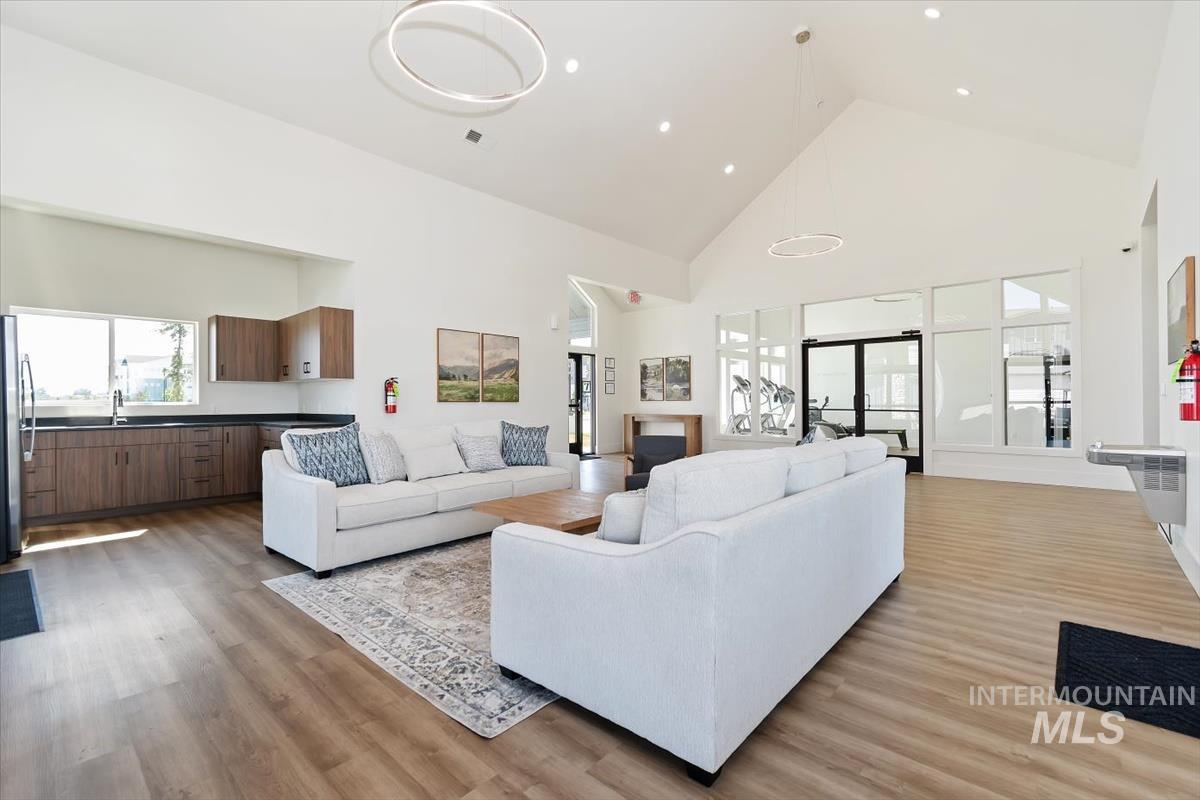 736 South Calhoun Lane Star, ID 83669 - Photo 34 of 42 Living room featuring a high ceiling, light wood-style flooring, and recessed lighting
