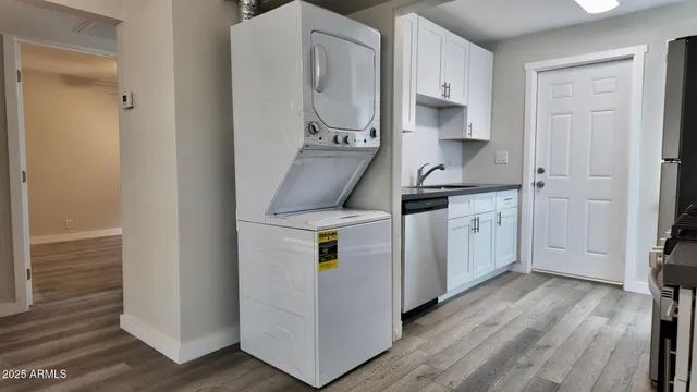 a kitchen with a sink cabinets and wooden floor