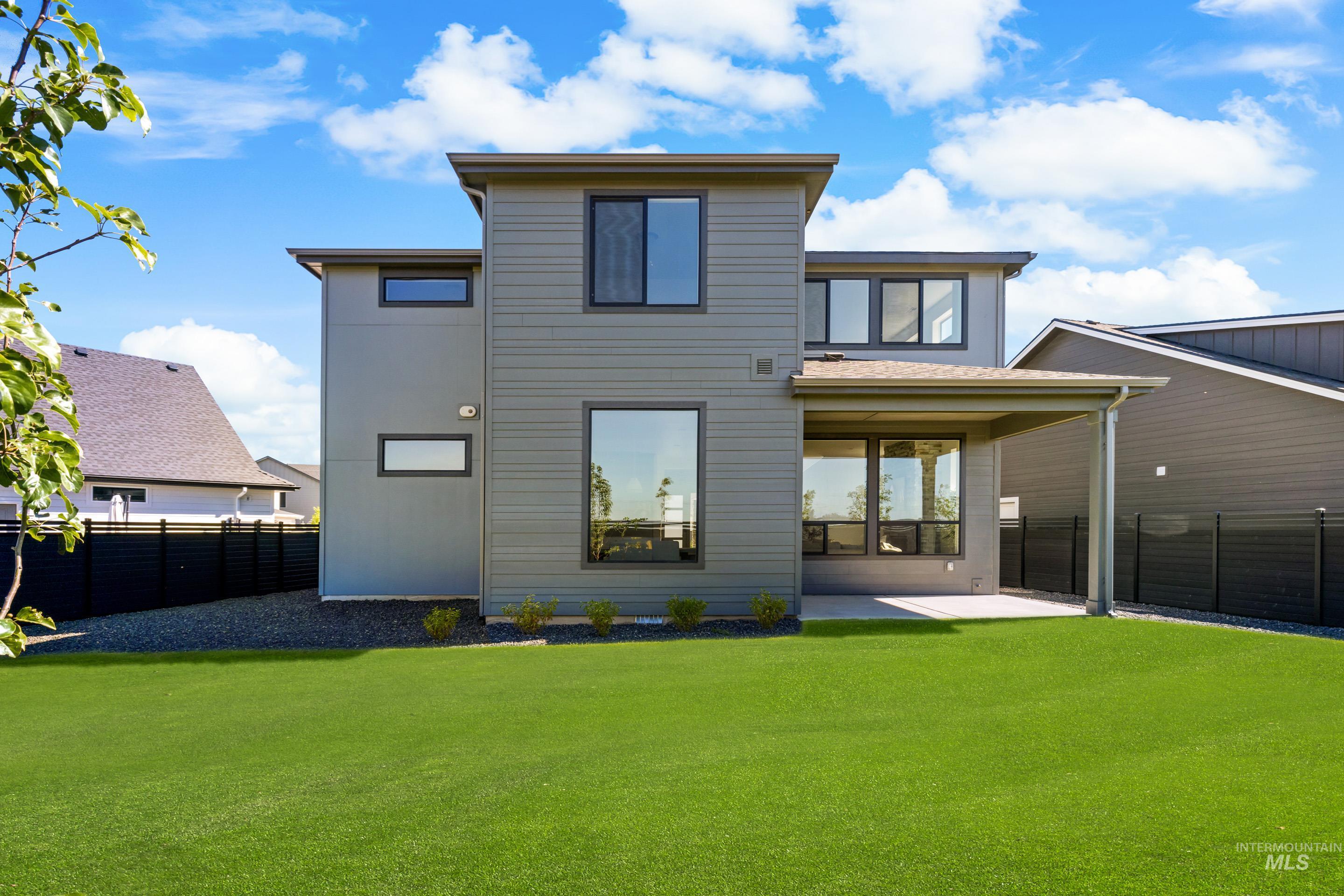 7649 West Whisper Ridge Drive, Unit ROUGE Meridian, ID 83646 - Photo 48 of 48 Back of property with a patio area and a fenced backyard