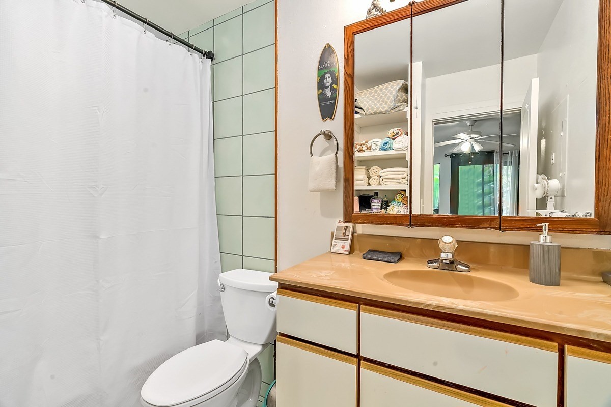 6384 Makana Road, Unit 2 Kapaa, HI 96746 - Photo 21 of 25 a bathroom with a sink toilet and shower