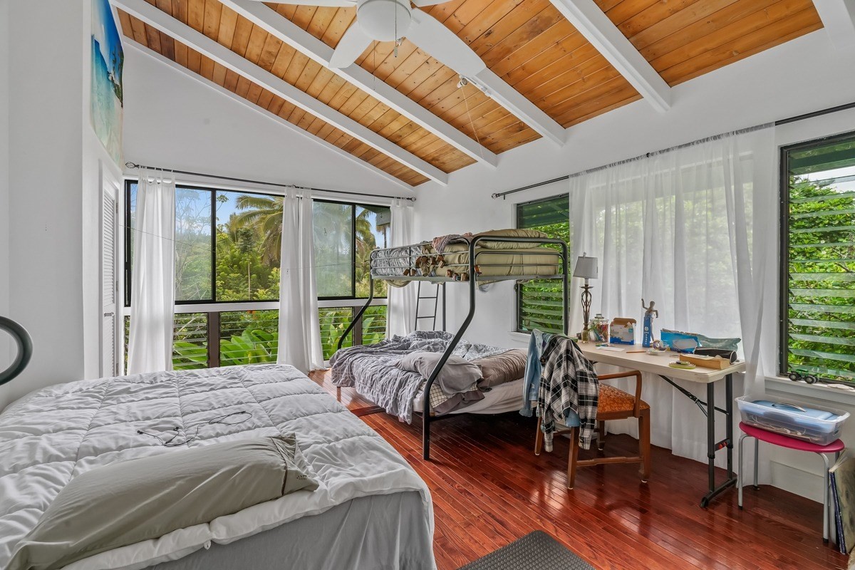 6384 Makana Road, Unit 2 Kapaa, HI 96746 - Photo 3 of 25 a bed sitting in a bedroom next to a window