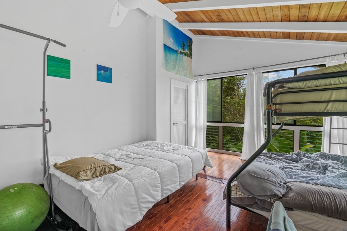 6384 Makana Road, Unit 2 Kapaa, HI 96746 - Photo 4 of 25 a bedroom with a bed window and glass door