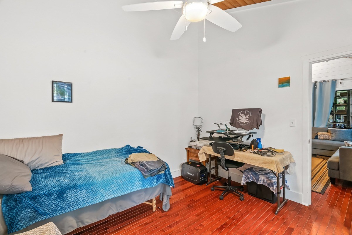 6384 Makana Road, Unit 2 Kapaa, HI 96746 - Photo 7 of 25 a bedroom with a bed and a chandelier