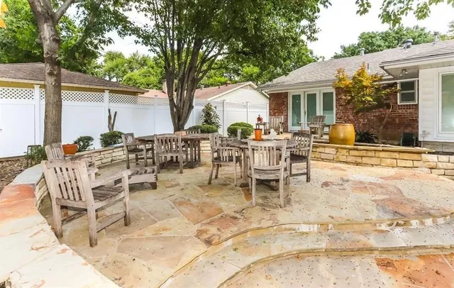 a view of a patio with table and chairs and potted plants