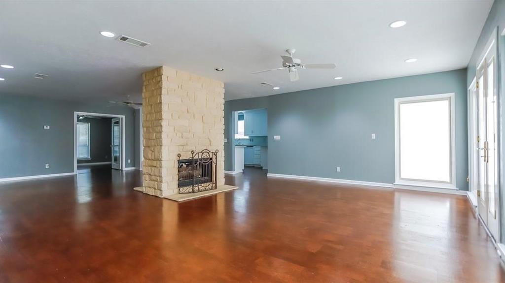 614 Twilight Trail Richardson, TX 75080 - Photo 4 of 24 an empty room with wooden floor and windows