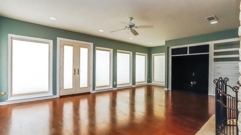 614 Twilight Trail Richardson, TX 75080 - Photo 7 of 24 a view of an empty room with wooden floor and a window
