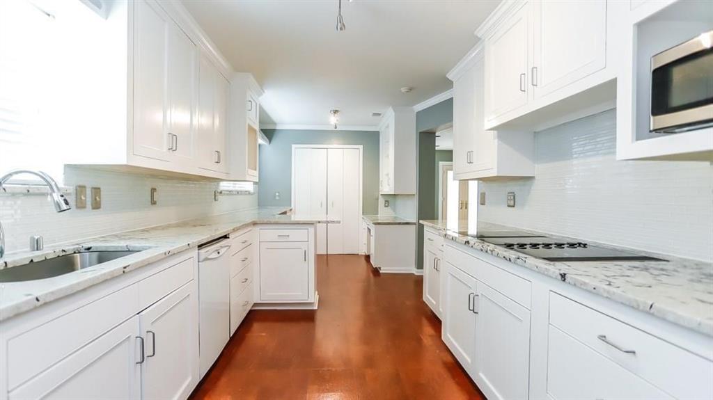 614 Twilight Trail Richardson, TX 75080 - Photo 8 of 24 a kitchen with granite countertop cabinets stainless steel appliances a sink and a counter top space