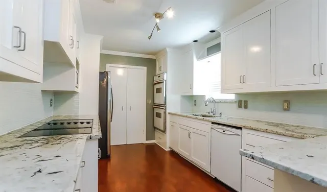 a kitchen with stainless steel appliances granite countertop a sink stove and refrigerator
