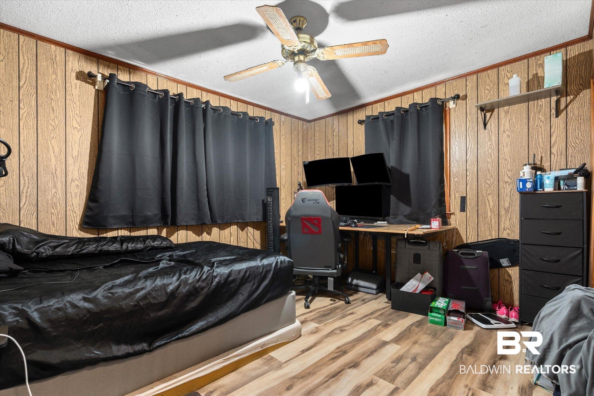 11601 Lott Road Chunchula, AL 36521 - Photo 12 of 34 Bedroom featuring wooden walls, light wood-type flooring, a textured ceiling, and ceiling fan