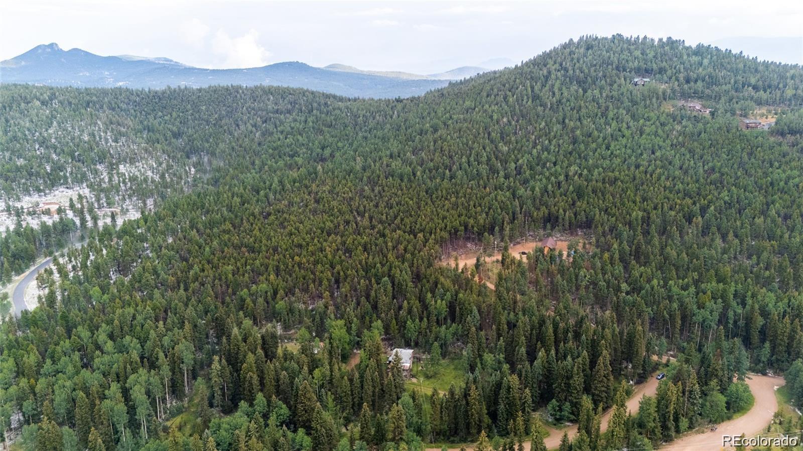 11173 Barney Gulch Road Conifer, CO 80433 - Photo 8 of 16 a view of a town with mountains in the background