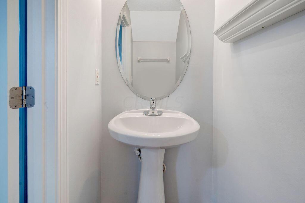 6345 Needletail Road, Unit 24634 Columbus, OH 43230 - Photo 28 of 58 • New luxury vinyl plank flooring ~ 2021 • Gray painted walls • Pedestal sink • Ceiling exhaust • Studio lighting strip