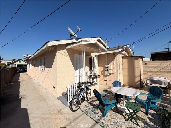 a view of a patio with table and chairs with the umbrella