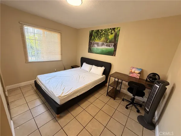 a bedroom with a bed and a desk