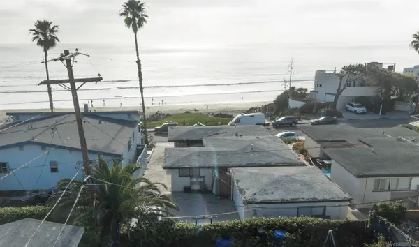 a view of swimming pool with outdoor seating and a ocean view in back