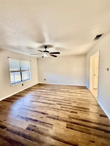 a view of a room with wooden floor and cabinet