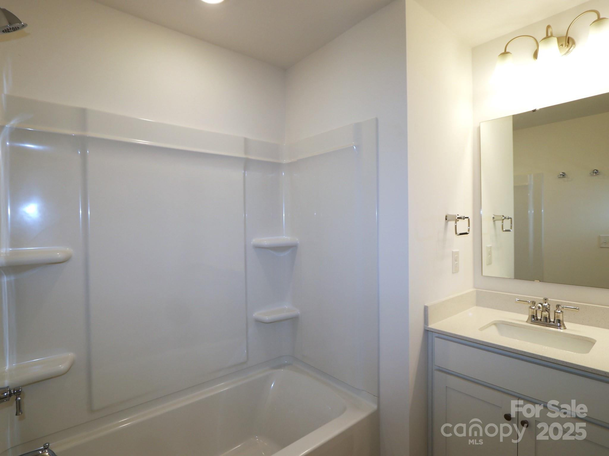 1014 Overbrook Place Wingate, NC 28174 - Photo 15 of 21 a bathroom with a bathtub sink vanity and toilet