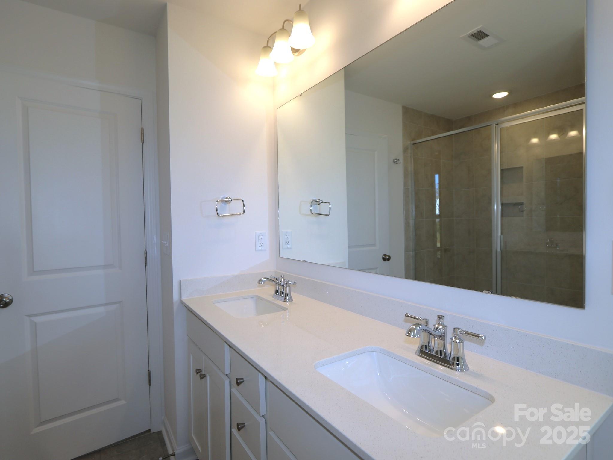 1014 Overbrook Place Wingate, NC 28174 - Photo 21 of 21 a bathroom with a sink double vanity and a mirror