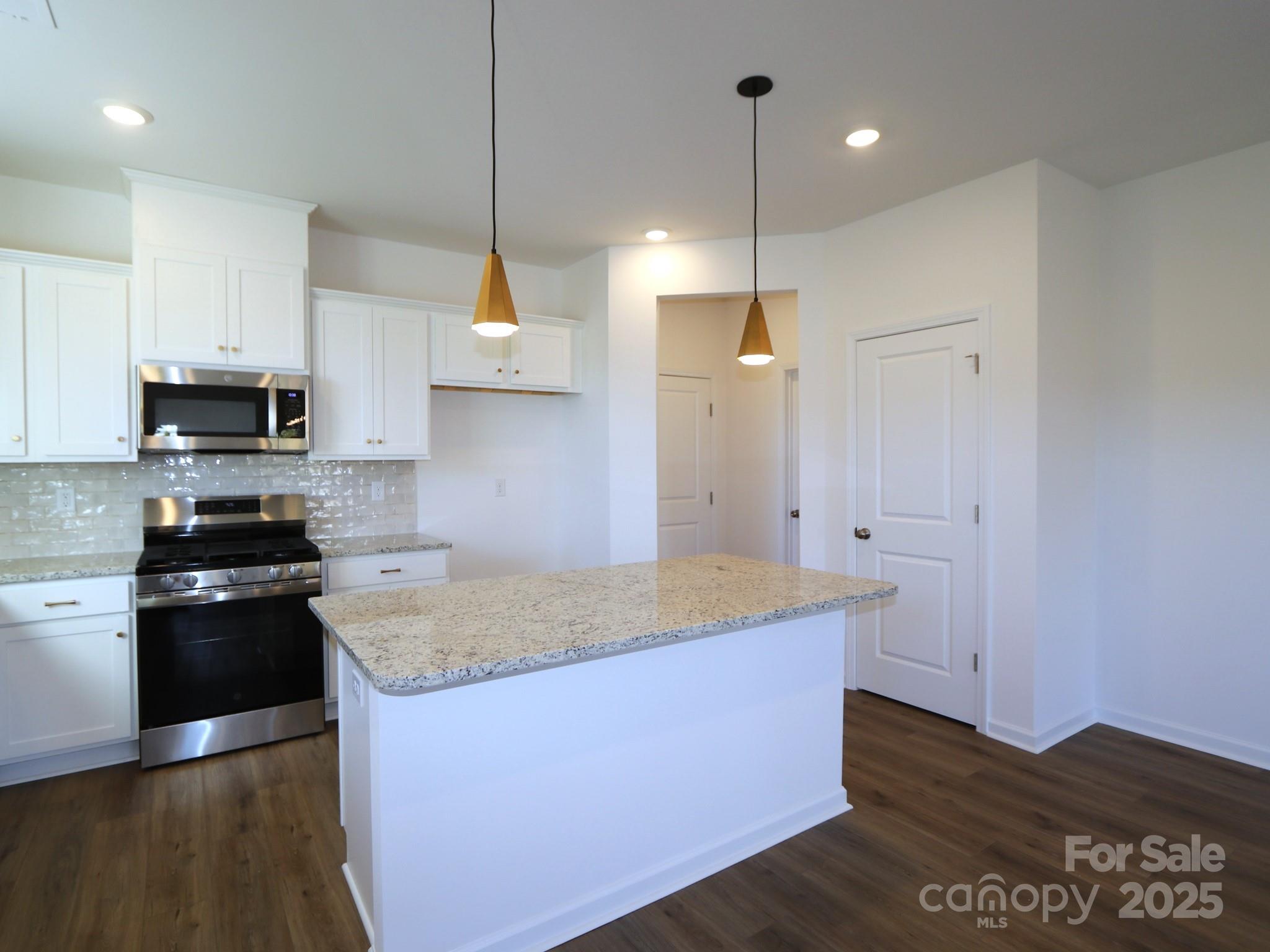 1014 Overbrook Place Wingate, NC 28174 - Photo 4 of 21 a kitchen with stainless steel appliances granite countertop a sink a stove and a refrigerator