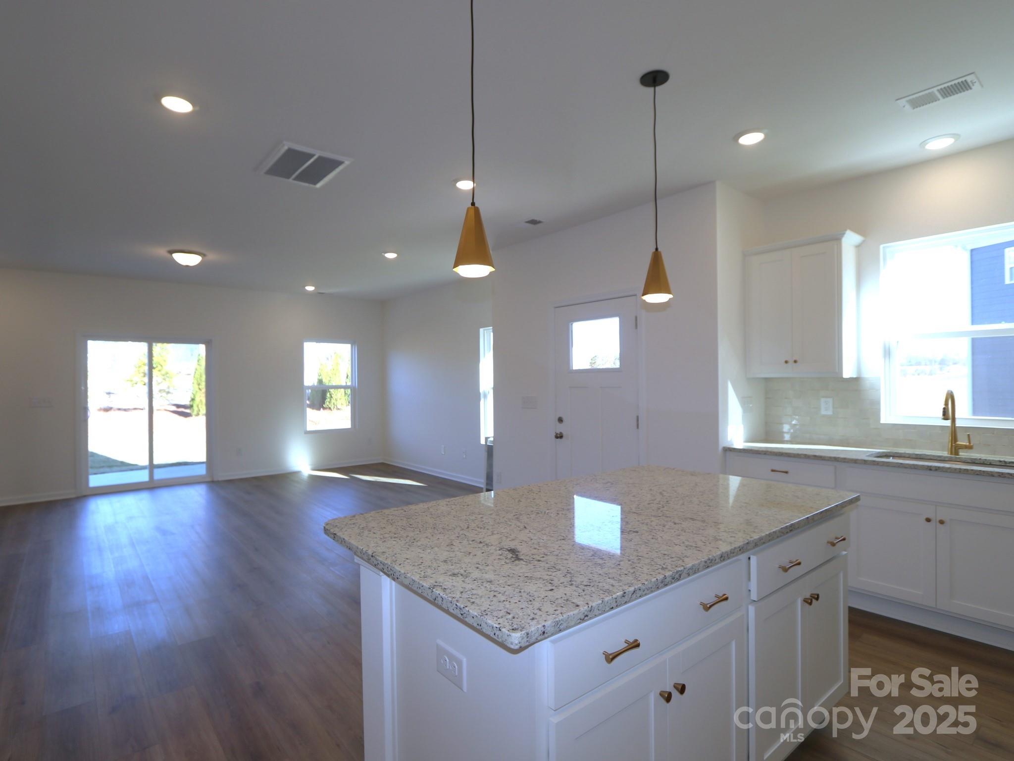 1014 Overbrook Place Wingate, NC 28174 - Photo 5 of 21 a kitchen with granite countertop a sink a counter space and a window