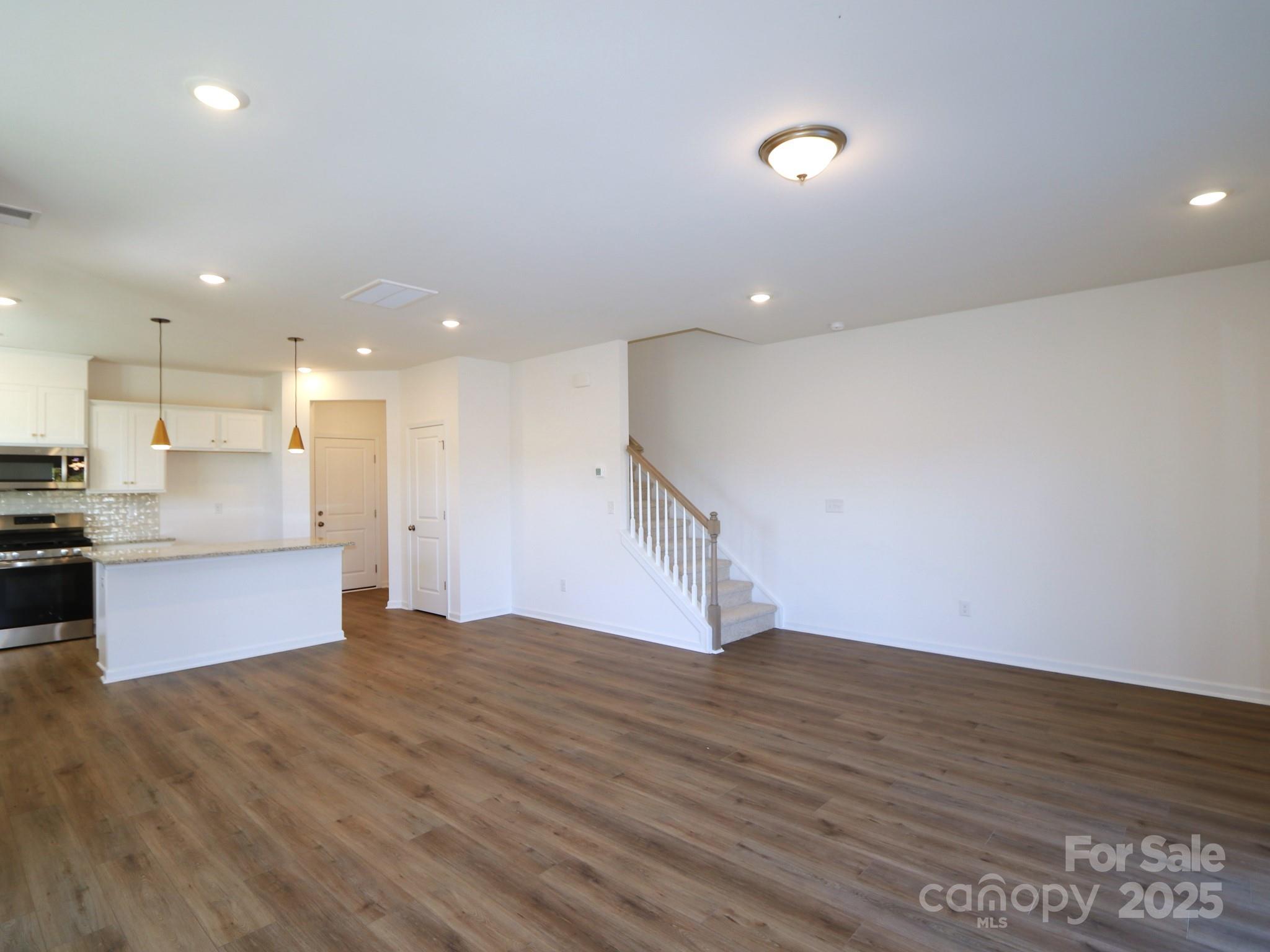 1014 Overbrook Place Wingate, NC 28174 - Photo 7 of 21 a view of kitchen with kitchen island wooden floor center island and stainless steel appliances