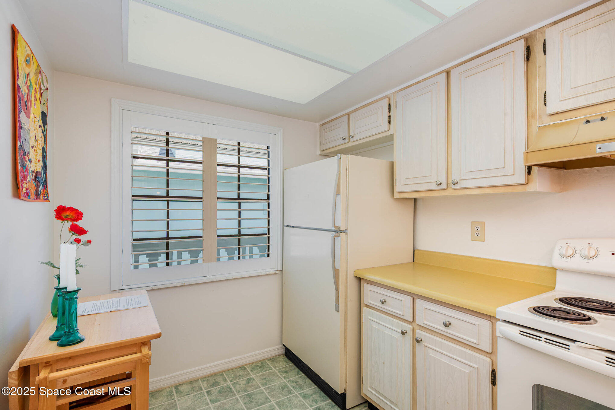1999 South Banana River Boulevard, Unit 313 Cocoa Beach, FL 32931 - Photo 11 of 24 a kitchen with stainless steel appliances cabinets and a window