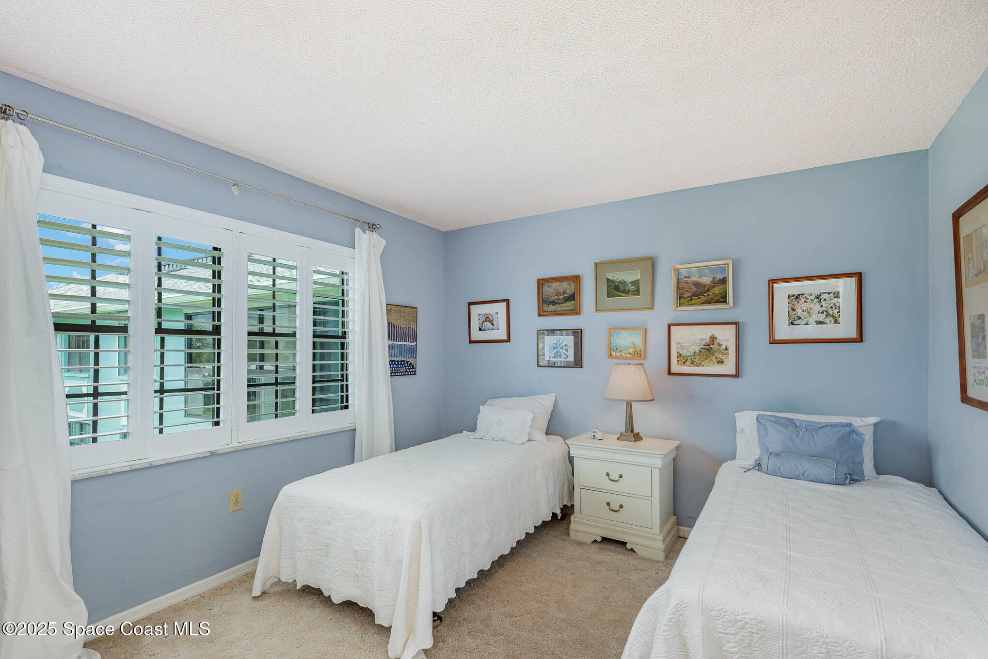 1999 South Banana River Boulevard, Unit 313 Cocoa Beach, FL 32931 - Photo 15 of 24 a bedroom with a bed and a large window