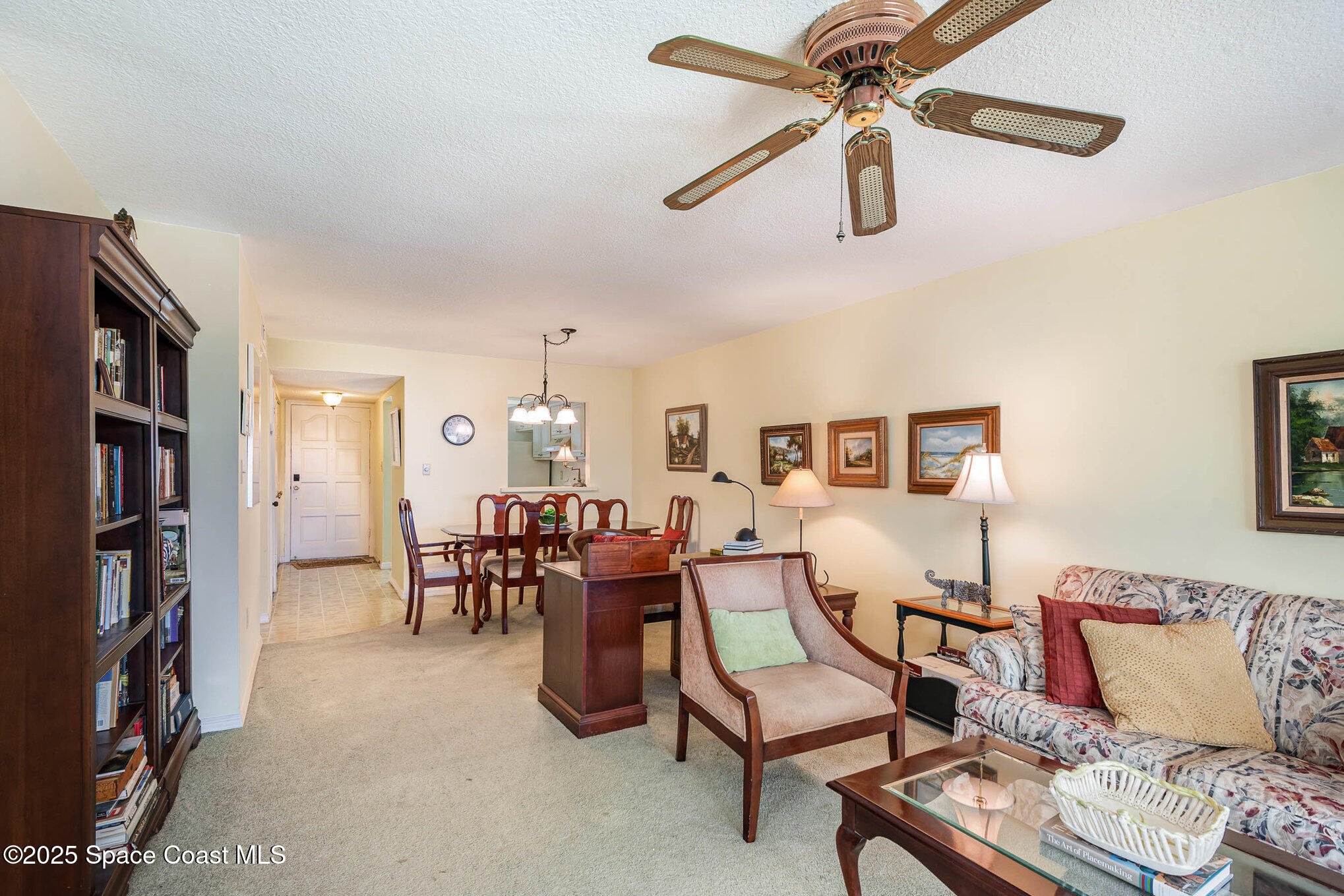 1999 South Banana River Boulevard, Unit 313 Cocoa Beach, FL 32931 - Photo 7 of 24 a living room with furniture and a bookshelf