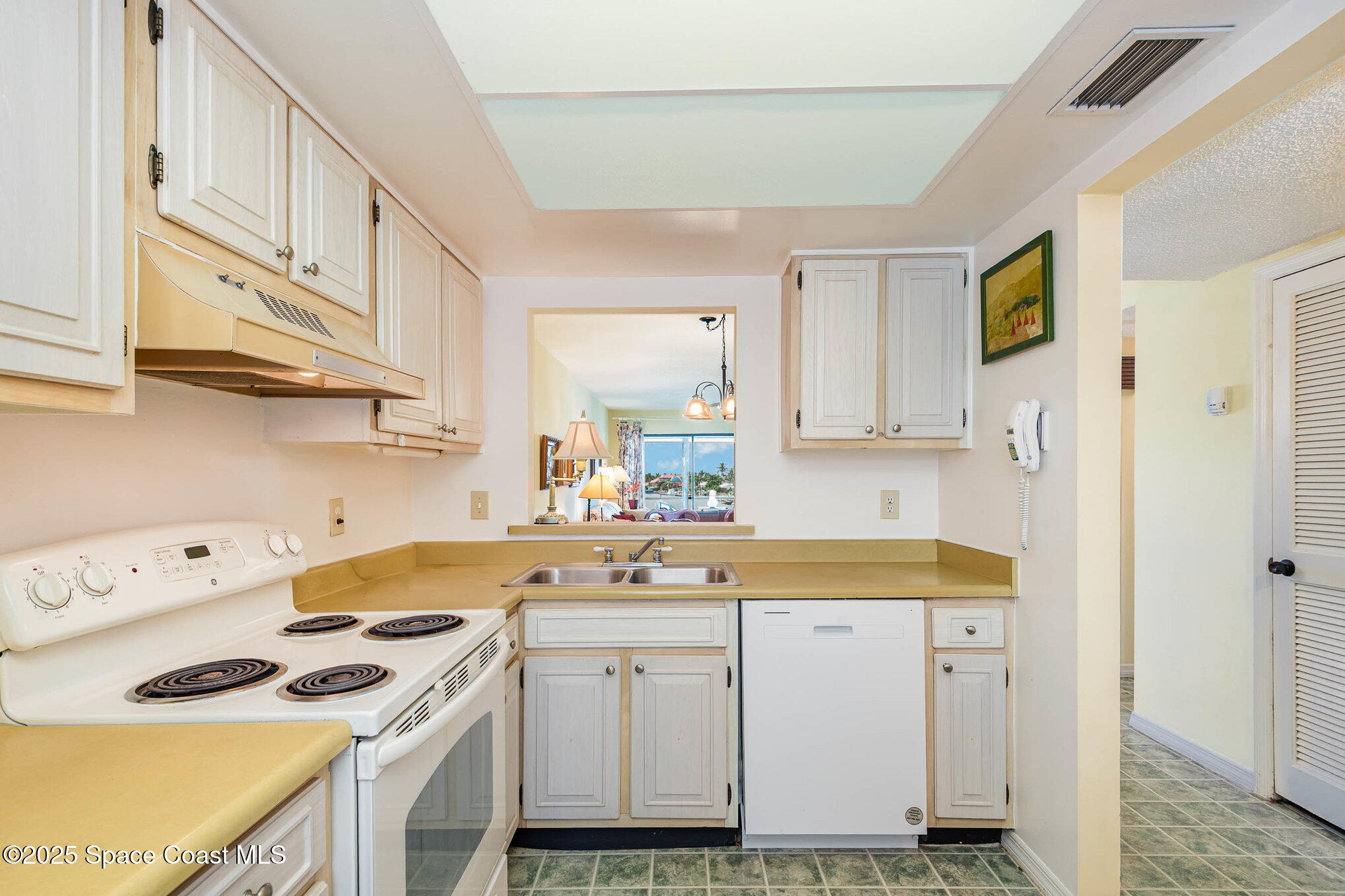 1999 South Banana River Boulevard, Unit 313 Cocoa Beach, FL 32931 - Photo 9 of 24 a kitchen with cabinets appliances a sink and a counter top space
