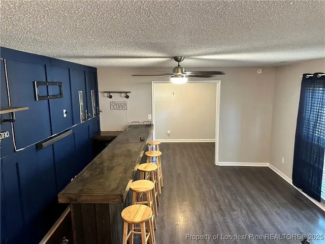 a living room with wooden floor and furniture