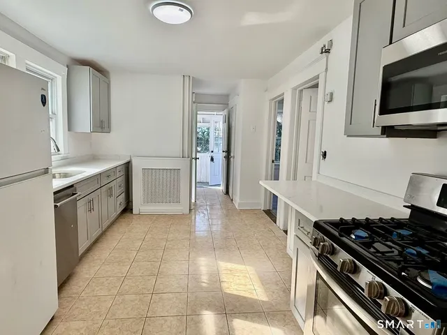 a bed with a black and white comforter