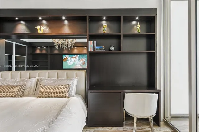 a large bedroom with a bed and a chandelier