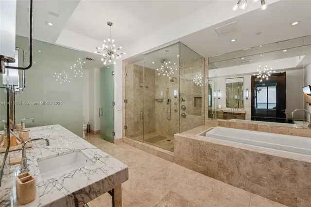 a spacious bathroom with a granite countertop sink a mirror a shower and a bathtub