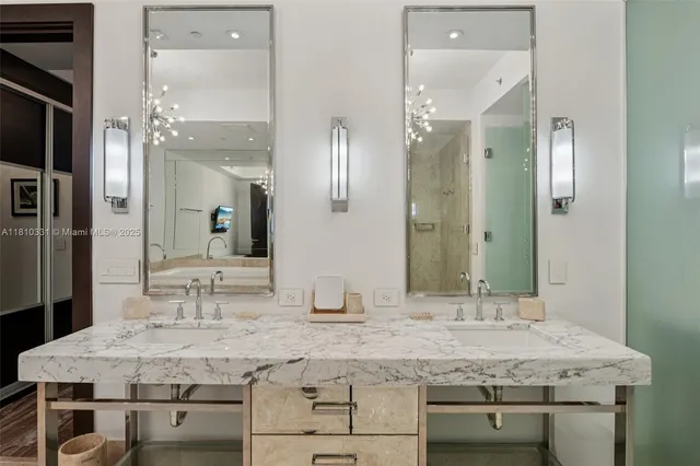 a spacious bathroom with a granite countertop sink a toilet a mirror and shower