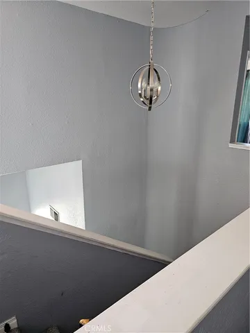 a view of a room with a fan and a window