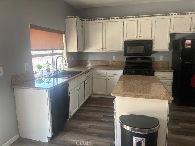 a kitchen with a sink a stove and refrigerator