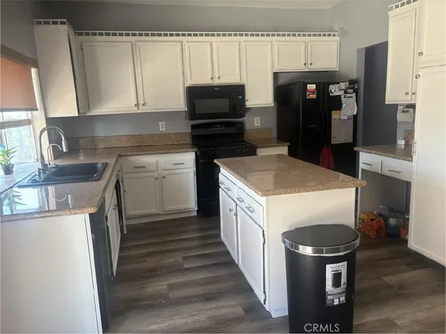 a kitchen with a stove and a refrigerator