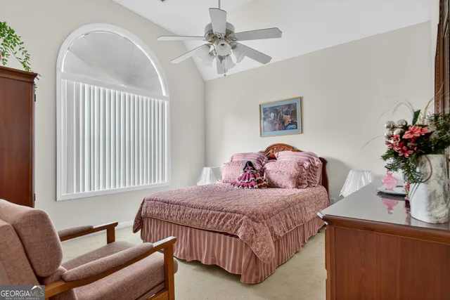 a living room with furniture ceiling fan and a rug