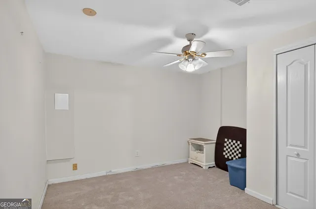 a view of a white house with a big yard and a large trees